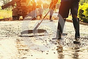 worker mix cement for building road at construction