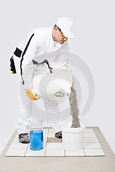 Worker mix tile adhesive bucket of water white tiles