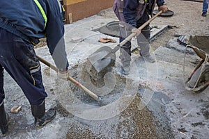Worker is mixing the cement by hand