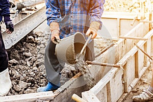 Worker mixing cement mortar plaster for construction