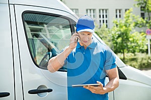 Worker With Mobile Phone And Digital Tablet