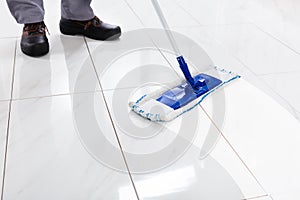 Worker Mopping Floor