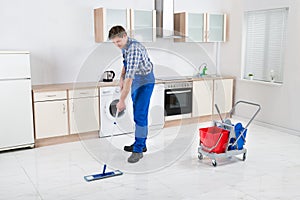 Worker Mopping Floor