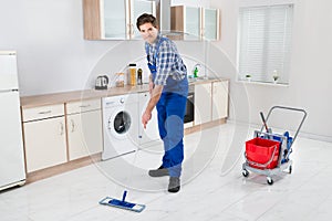 Worker Mopping Floor