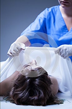 Worker of mortuary covering the dead body