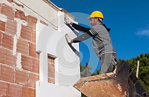 Worker mounts sheets of polystyrene photo