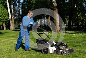 The worker mows the grass image,an emloyee mows the lawn