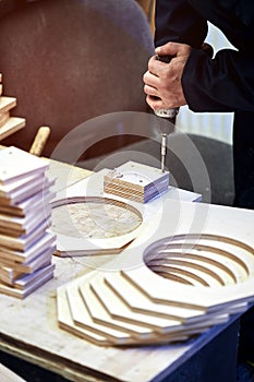 Worker with nailing gun in a workshop