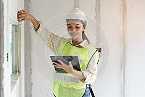 Worker occupation. Woman inspector / architect checking interior material process in house reconstruction project