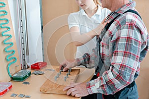 Worker in occupational therapy re-learning to lay bricks