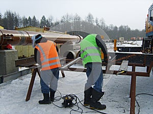 The worker is occupied with welding works