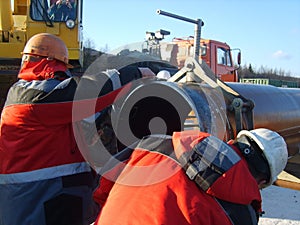 The worker is occupied with welding works