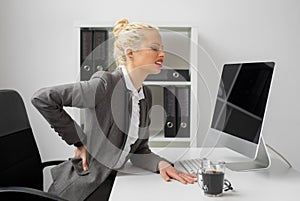 Worker at the office with terrible back pain