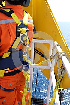 Worker at offshore with safety harness.