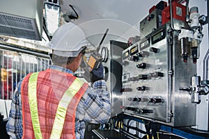 Worker in oil rig plant hand holding walkie talkie