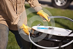 Worker Opening or Sealing Utility Drum