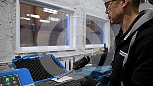 A worker opens the suitcase