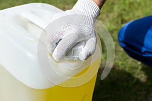 Worker opens up a can of yellow paint