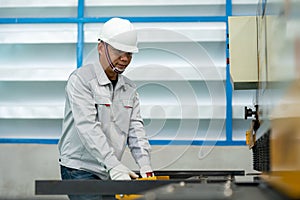 The worker operate bending machine in the construction machine factory