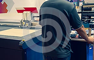 Worker operate digital cutting machine