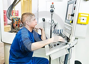 Worker operating CNC machine center