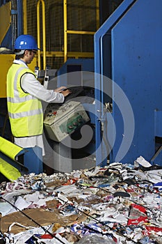 Worker Operating Conveyor Belt In Recycling Factory