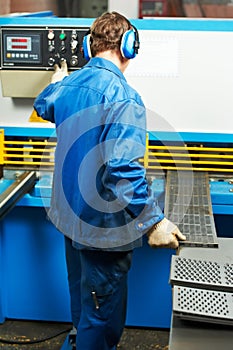 Worker operating guillotine shears