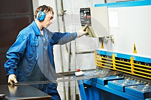 Worker operating guillotine shears