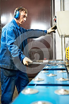 Worker operating guillotine shears machine photo