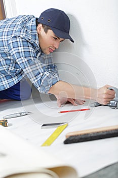 Worker in overall cutting insulating material