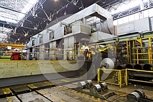 Worker oversees the process of aluminum rolling