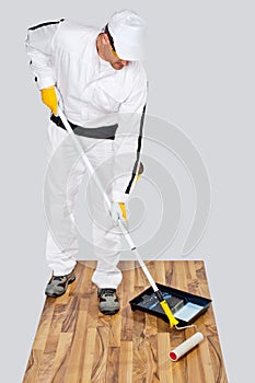 Worker paint primer wooden floor photo