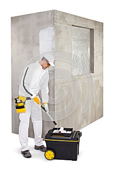 Worker with a painter roller brush and primer