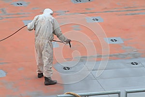 Worker painting ship
