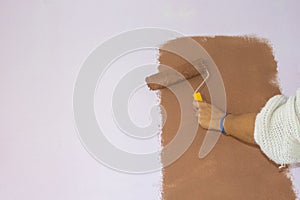 Worker Painting on Surface Wall Painting Apartment, Roller Brush Painting, Renovating with Color Paint. Leave empty Copy Space to