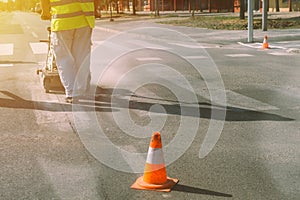 Worker is painting zebra pedestrian crosswalk