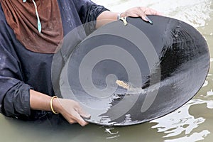 Worker panning for natural placer gold photo