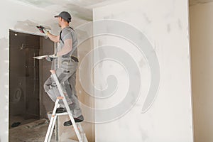 Worker Patching Drywall