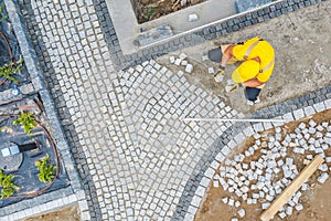 Worker Paving Garden Path Aerial Vista