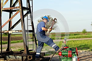 Worker with pipe wrench on pipeline