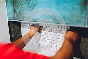 Worker placing ceramic mosaic boards on flexible adhesive. Worker hands working with ceramic tiles