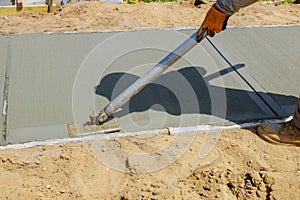 Worker plastering the concrete cement during sidewalk