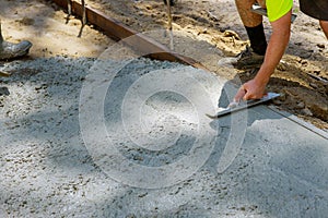 Worker plastering the concrete cement during sidewalk