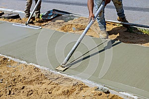 Worker plastering the concrete cement during sidewalk