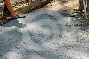 Worker plastering the concrete cement during sidewalk