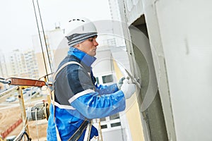 Worker at plastering facade work