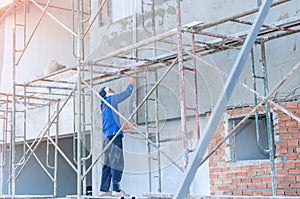 Worker with plastering tools create. builder worker plastering facade