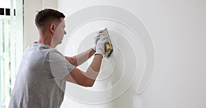 Worker is plastering wall before painting