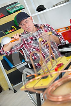 worker plumber using blowtorch for soldering copper fittings