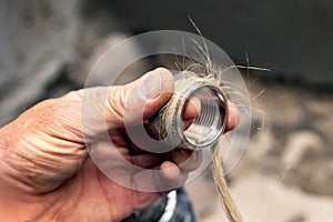 Worker, plumber winds tow on the sleeve for threaded conne